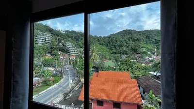 a view from a window of a town with a road at Coco Mountain View Guest House Hotel in Kata Beach