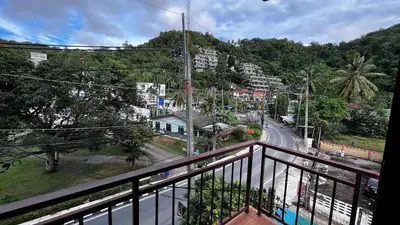 a balcony with a view of a city street at Coco Mountain View Guest House Hotel in Kata Beach
