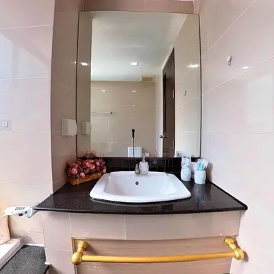 a bathroom with a sink and a mirror at The Kris 2 Bedrooms 2 Bathrooms Apartment in Patong Beach