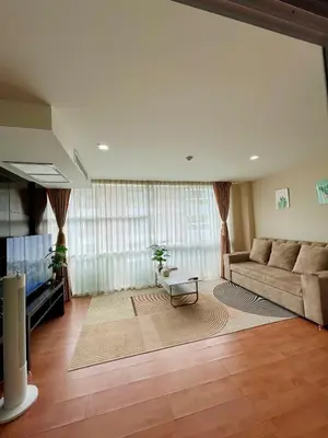 a living room with a couch and a tv at The Kris 2 Bedrooms 2 Bathrooms Apartment in Patong Beach