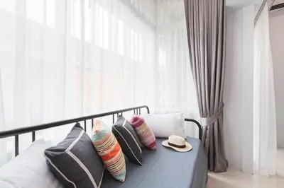 a bedroom with a bed with pillows and a hat at Reach Patong beach in one minute in Patong Beach