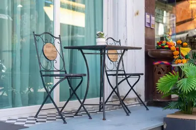a black table and two chairs on a porch at Reach Patong beach in one minute in Patong Beach