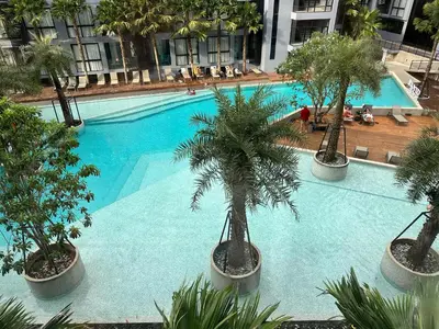 an overhead view of a large swimming pool with palm trees at Kamala Beach P33 Pool view 2 Bedroom Suite in Kamala Beach