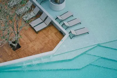 an overhead view of a pool with tables and chairs at Kamala Beach P33 Pool view 2 Bedroom Suite in Kamala Beach