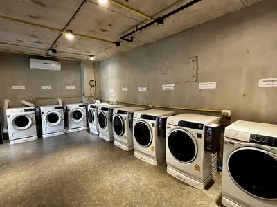 a laundry room with a row of washers and dryers at Kamala Beach P33 Pool view 2 Bedroom Suite in Kamala Beach