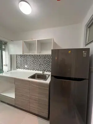 a kitchen with a stainless steel refrigerator and a sink at Vibe Old Town 452 in Phuket Town
