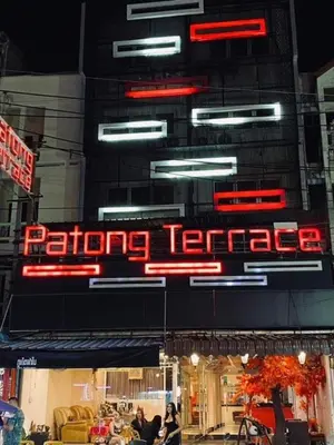 a sign for a restaurant with neon signs on a building at Patong Terrace Hotel in Patong Beach