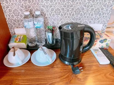 a table with a coffee pot and plates and water bottles at Patong Terrace Hotel in Patong Beach
