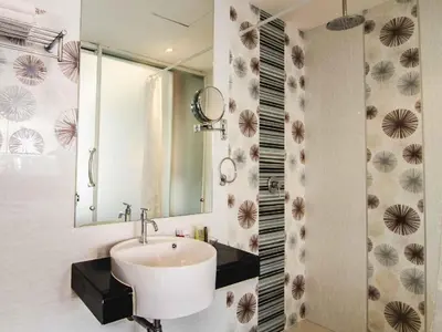 a bathroom with a sink and a mirror at Patong Terrace Hotel in Patong Beach