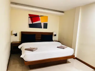 a bedroom with a bed with two towels on it at Patong Terrace Hotel in Patong Beach