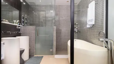 a bathroom with a shower and a tub and a toilet at The Natai Villas - By AP Natai in Phang-nga