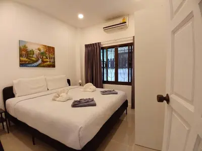 a bedroom with a bed with towels on it at Bayok 11 - 2 Bedrooms 2 Bathrooms Villa Near Kathu Waterfall in Ban Huai Luk (1)