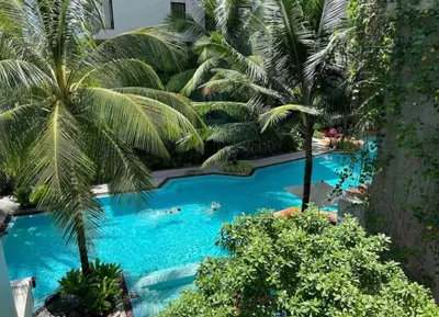 an overhead view of a swimming pool with palm trees at Bangtao Beach Apartments in Bang Tao Beach