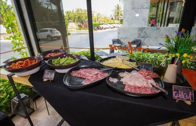 a table with many different types of food on it at Bangtao Beach Apartments in Bang Tao Beach