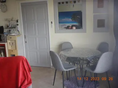 a room with a table and chairs and a door at Homely with pool near the beach in Kamala Phuket in Kamala Beach