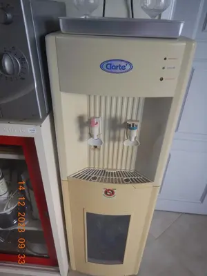 a drink dispenser in a kitchen next to a stove at Homely with pool near the beach in Kamala Phuket in Kamala Beach