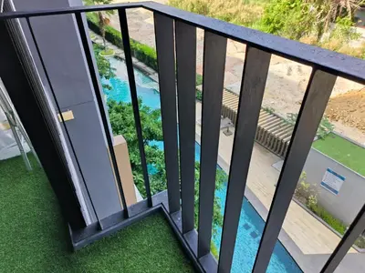 a balcony with a view of a swimming pool at The Aristo 1 Condo Surin Beach in Phuket Town