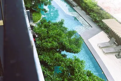 an overhead view of a swimming pool with trees at The Aristo 1 Condo Surin Beach in Phuket Town