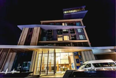 a building with a car parked in front of it at The Aristo 1 Condo Surin Beach in Phuket Town