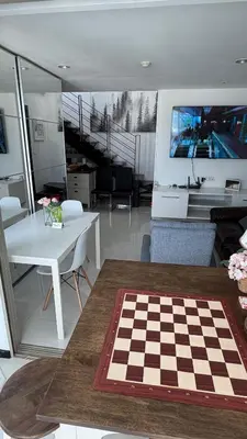a living room with a chess board on a table at The Regent Kamala Penthouse with private pool in Kamala Beach