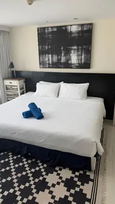 a large white bed with a blue towel on it at The Regent Kamala Penthouse with private pool in Kamala Beach