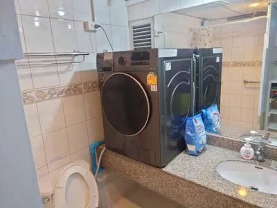 a washing machine sitting on a counter in a bathroom at Phuket Palace apartment with 2 separate rooms in Patong Beach