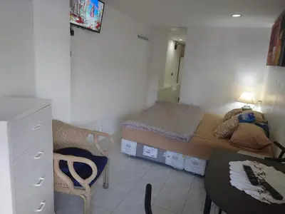 a small room with a small bed and a desk at Phuket Palace apartment with 2 separate rooms in Patong Beach