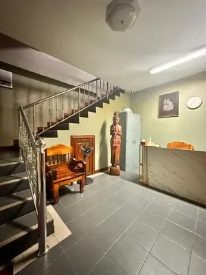 a living room with a staircase and a stair case at BT hotel Kata Beach in Kata Beach