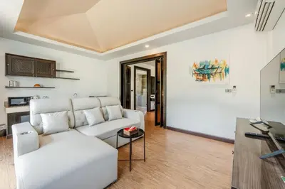 a living room with a white couch and a table at Coco Retreat Phuket Resort and Spa - SHA Plus in Chalong