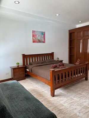 a bedroom with a bed with two teddy bears on it at BT hotel Kata Beach in Kata Beach