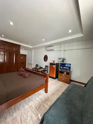 a bedroom with a bed and a living room at BT hotel Kata Beach in Kata Beach