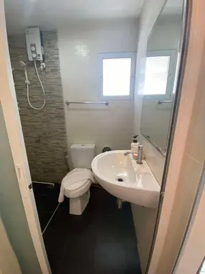 a bathroom with a sink and a toilet at The Elegant Patong in Patong Beach