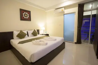 a bedroom with a large bed with two white dishes on it at The Elegant Patong in Patong Beach