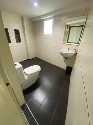 a bathroom with a toilet and a sink at The Elegant Patong in Patong Beach