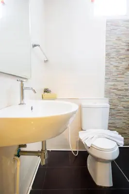 a bathroom with a white toilet and a sink at The Elegant Patong in Patong Beach