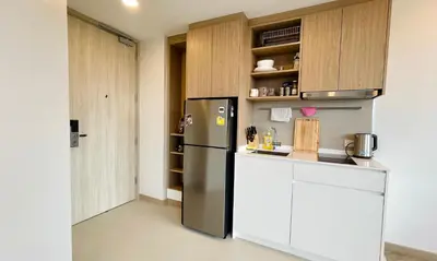a kitchen with a stainless steel refrigerator and cabinets at Laguna Skypark in Phuket Town