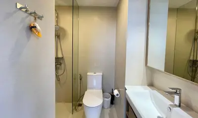 a bathroom with a shower and a toilet and a sink at Laguna Skypark in Phuket Town