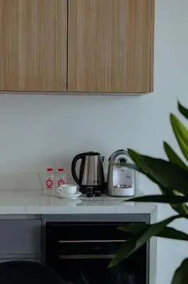 a kitchen counter with a coffee pot on a stove at Elite Atoll Serviced Apartments Phuket in Rawai Beach