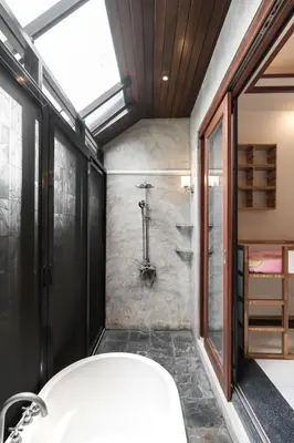 a bathroom with a bath tub and a shower at Villa Banyak Luxury 4Br villa with nice terrace in Rawai Beach