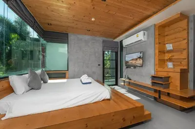 a bedroom with a large bed and a large window at Modern studio at Relife 2 min to Nai Harn beach in Rawai Beach