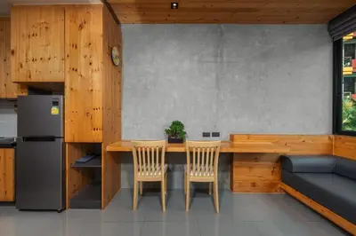 a kitchen with a table and two chairs and a refrigerator at Modern studio at Relife 2 min to Nai Harn beach in Rawai Beach