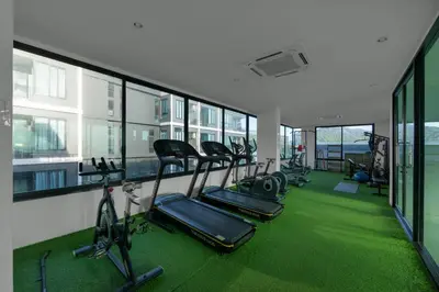 a gym with a row of treadmills and exercise bikes at Modern studio at Relife 2 min to Nai Harn beach in Rawai Beach