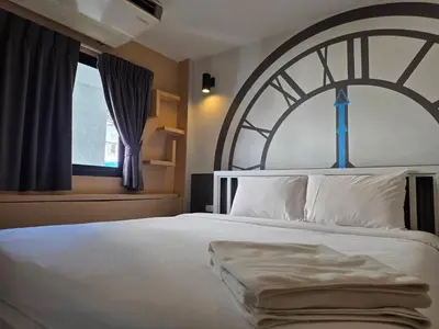 a bedroom with a large bed and a window at Terminal58hostel@town in Ban Lo Long
