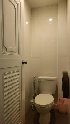 a bathroom with a white toilet and a phone at Terminal58hostel@town in Ban Lo Long