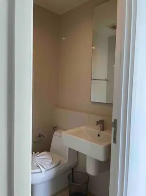 a bathroom with a sink and a toilet and a mirror at Luxury condo in phuket shopping center in Phuket Town