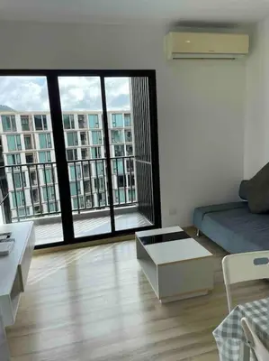 a living room with a couch and large windows at Luxury condo in phuket shopping center in Phuket Town