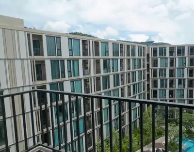 a large building with many windows and a balcony at Luxury condo in phuket shopping center in Phuket Town