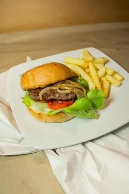 a sandwich and french fries on a white plate at Kamala Beach Residence in Kamala Beach