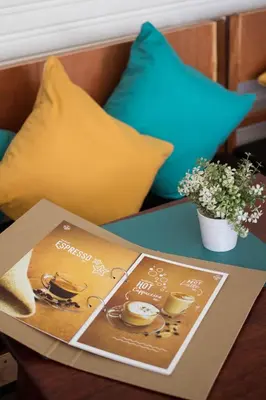 a table with a book on it on a table with pillows at Kamala Beach Residence in Kamala Beach