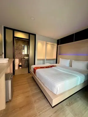 a bedroom with a large bed and a bathroom at Phi Phi Rimlay Resort in Phi Phi Don